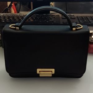 Black purse clutch with short handle. Gently used